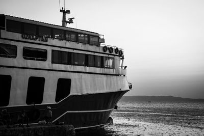 Ship moored on beach against clear sky