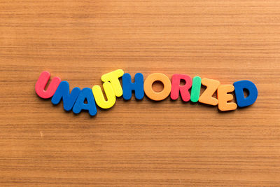 Multi colored toys on table against blue background