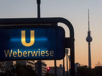 Information sign in city against clear sky