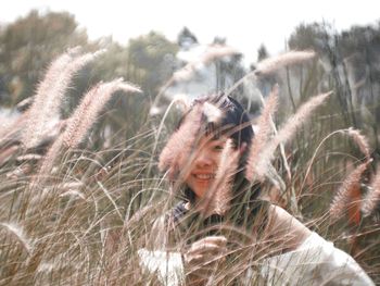 Portrait of young woman with plants