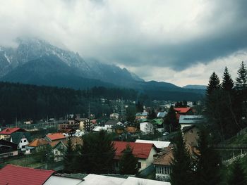 Houses against mountains and cloudy sky