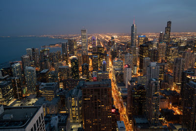 High angle view of illuminated city buildings against sky