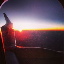 Cropped image of airplane at sunset