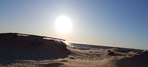 Scenic view of sea against clear sky on sunny day