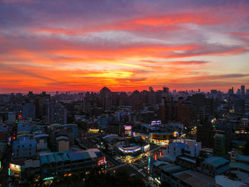 High angle view of illuminated buildings against sky during sunset