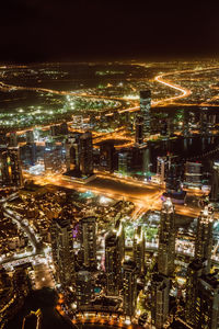 High angle view of illuminated cityscape against sky at night