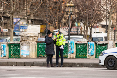 Full length of man standing on street in city