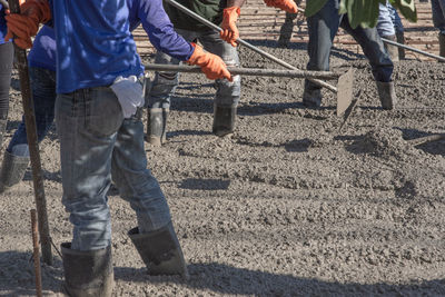 Midsection of men working at construction site