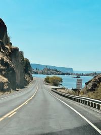 Road by sea against sky