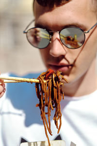 Close-up portrait of young man wearing sunglasses