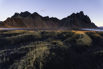 Scenic view of land and mountains against sky