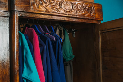 Second hand wardrobe, vintage clothes on hangers in the closet. circular economy, eco friendly