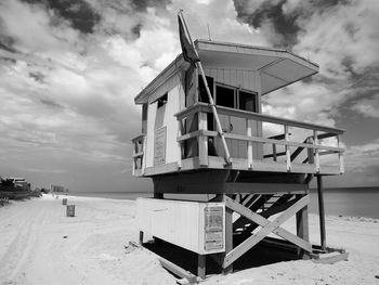 Boats in sea against cloudy sky