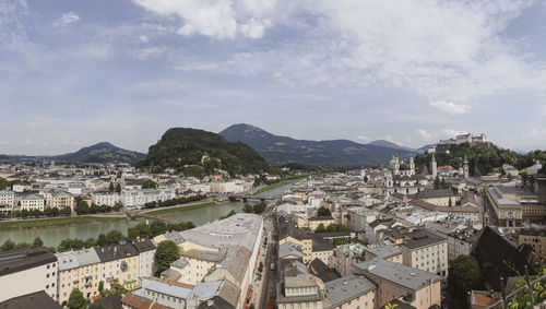 High angle view of townscape by river against sky