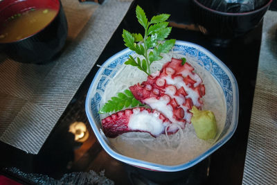 High angle view of tako serve with wasabi in bowl on table