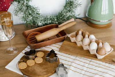 Kitchen utensils. christmas wreath, teapot, chicken eggs, champagne glasses, wooden rolling pins