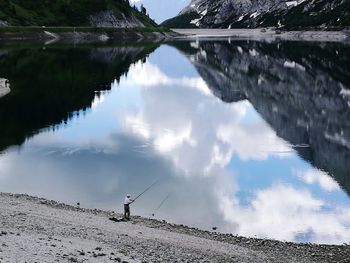 High angle view of man fishing in lake