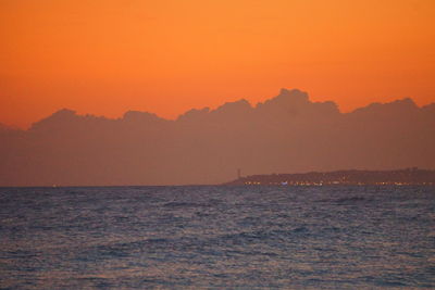 Scenic view of sea against orange sky