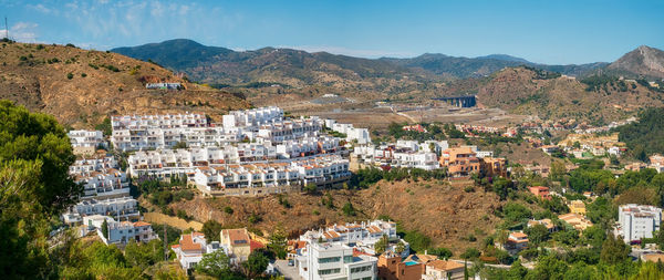 High angle view of townscape and mountains against sky