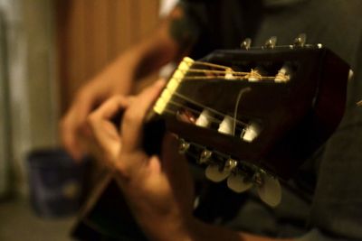 Close-up of man playing guitar