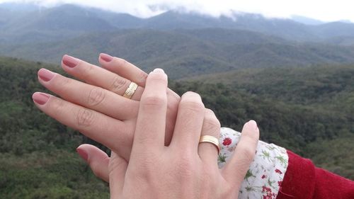 Cropped hand of couple with wedding rings