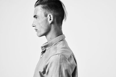 Portrait of young man against white background