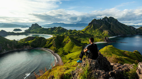 Man looking at view of mountains against sky