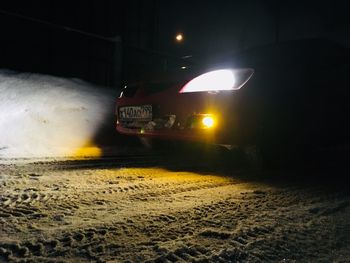 Car on illuminated street at night