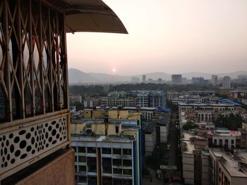 Aerial view of buildings against sky during sunset