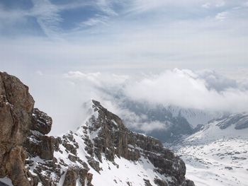 Scenic view of snow covered mountains against sky