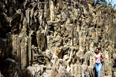 Panoramic view of people on rock in cave