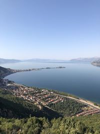 High angle view of sea and cityscape against sky