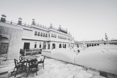 Empty chairs and tables on building terrace at alsisar mahal