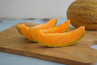 Close-up of orange slices on cutting board