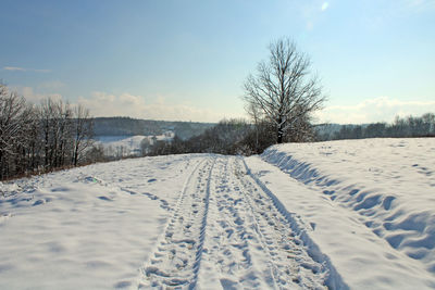 Snow covered field against sky