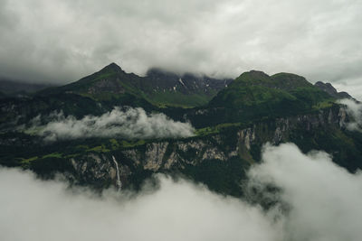 Scenic view of waterfall against sky