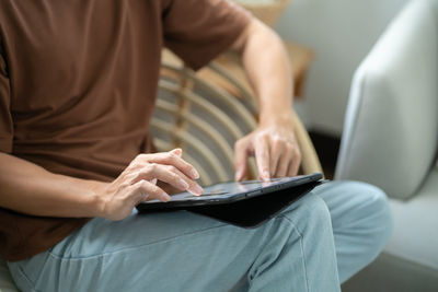 Midsection of woman using mobile phone