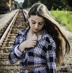 Close-up of young woman on railroad track