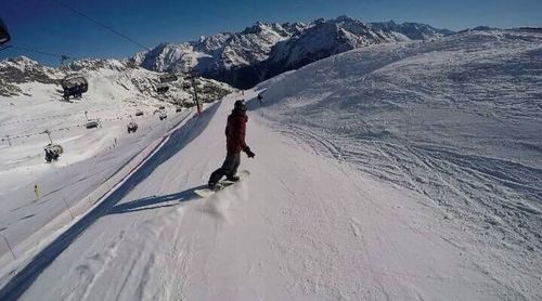 Person skiing on snow covered mountain