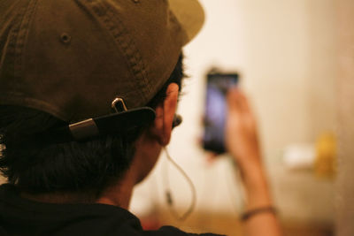 Rear view portrait of man holding smart phone