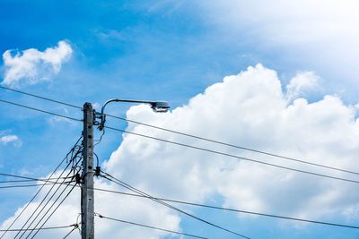 Low angle view of street light against sky