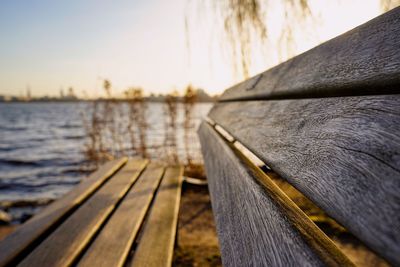 Close-up of boat on pier over lake against sky