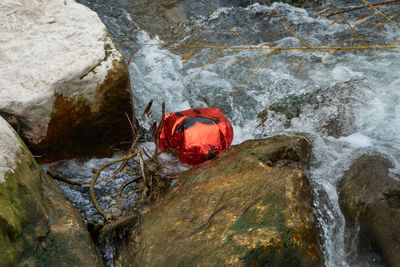 A red balloon with drawn a face with a mustache, floats on the surface of the water