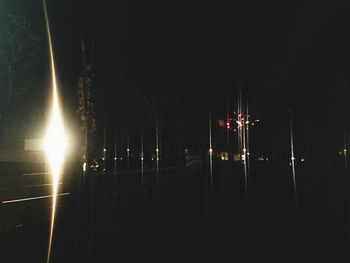 Illuminated tree against sky at night