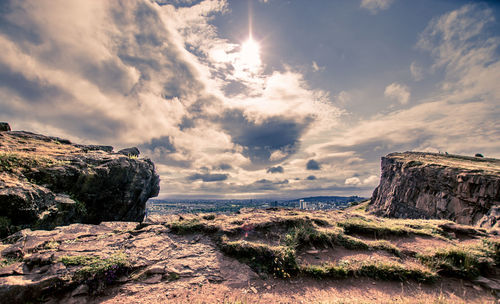 Scenic view of cliff over city against sky