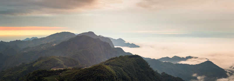 Scenic view of mountains against cloudy sky