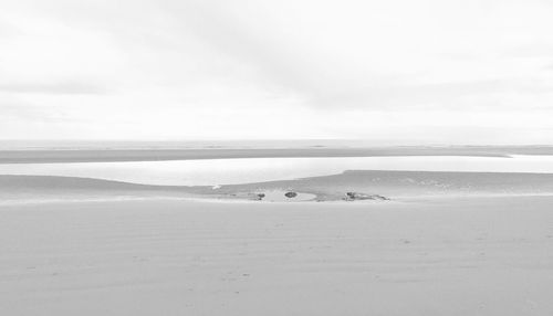 Scenic view of beach against sky during winter