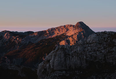 Scenic view of rocky mountains against sky during sunset