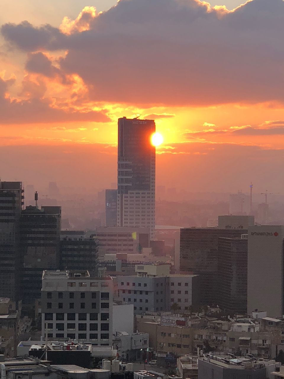 BUILDINGS IN CITY AGAINST SKY DURING SUNSET