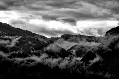 Scenic view of mountains against cloudy sky